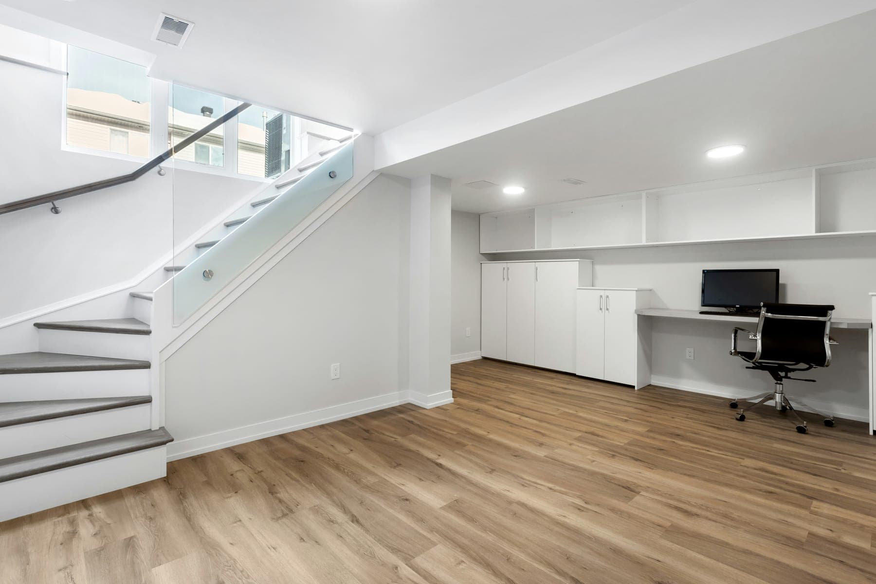 Open plan at the stair foot, with the built-in desk run